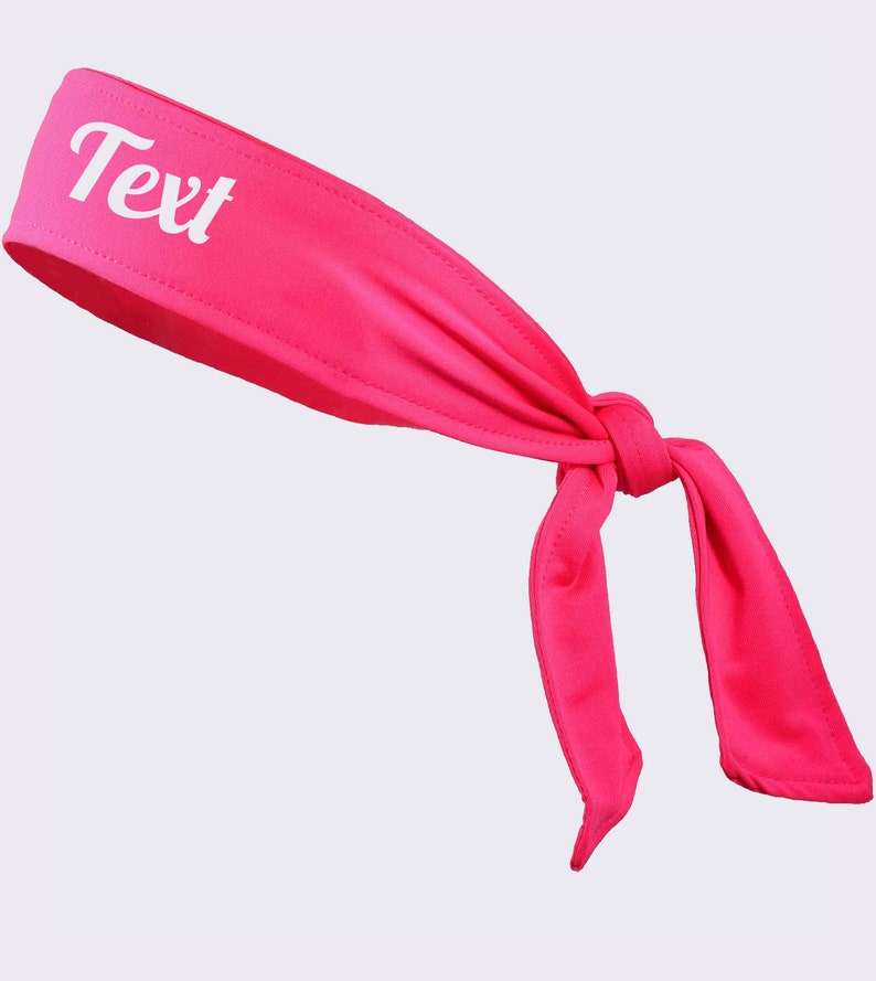 May include: A pink headband with a white knot and the word "Text" printed on it.
