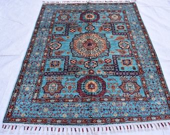May include: A blue and red patterned rug with a fringe border. The rug has a traditional design with intricate details.