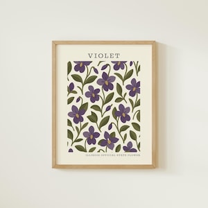 The image is a framed print featuring a repeating pattern of purple flowers with green leaves.
