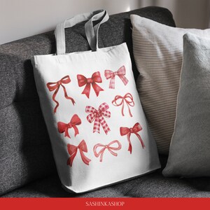 May include: A white canvas tote bag with a red and white bow design. The bag has a grey handle and the text "SASHINKASHOP" is printed on the bottom.