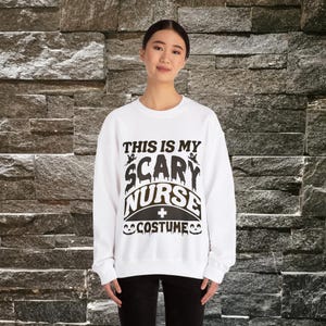 May include: White sweatshirt with black text that reads 