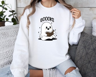 May include: White sweatshirt with a cute ghost reading a book and the text "BOOOKS".