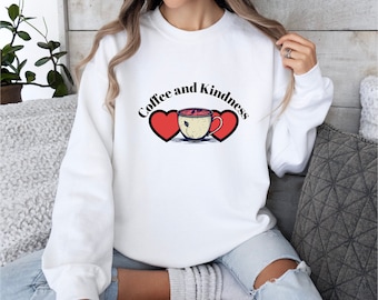 May include: White sweatshirt with the text "Coffee and Kindness" in black lettering, a red heart on each side of a coffee cup illustration.
