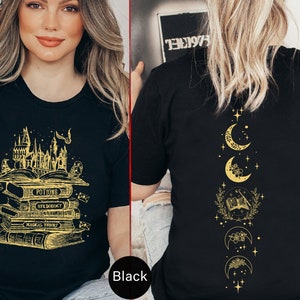 May include: Black t-shirt with a gold graphic of a stack of books with the words "Potions", "Herbology", "Magical Theory", and "Transfiguration" on the front. The back of the shirt features a gold graphic of a crescent moon with stars and a book.