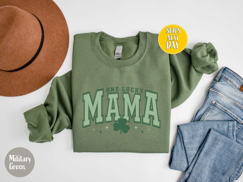 May include: A green sweatshirt with the text "One Lucky Mama" in white with a green shamrock underneath.