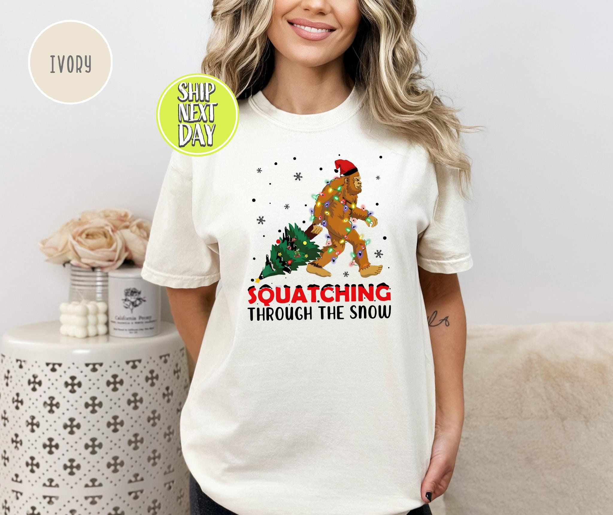 Squatching Through The Snow Big Foot T-Shirt, Christmas Lights T Shirt, Bigfoot Merry Tees, Sasquatch Christmas, Bigfoot Lover Tee -CC169
