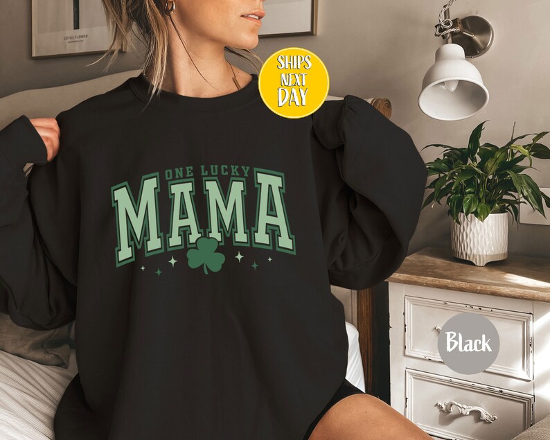 May include: Black sweatshirt with a green shamrock and the text "One Lucky Mama" in white.