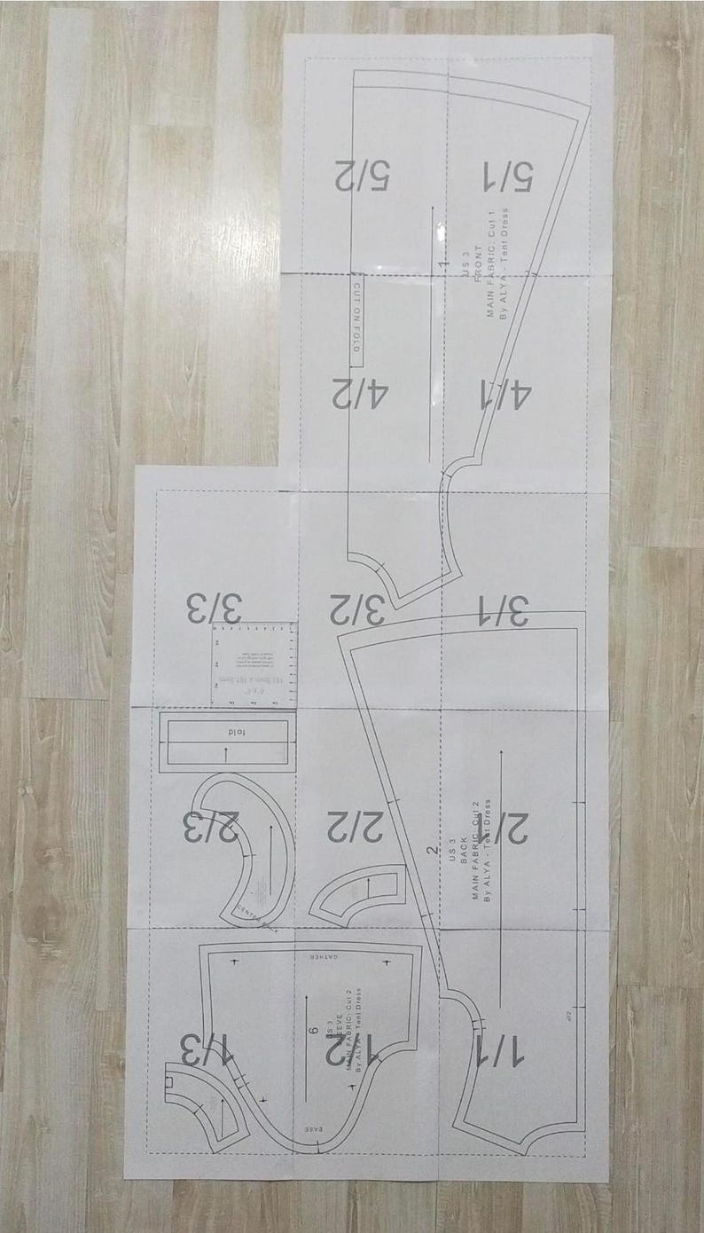 May include: A sewing pattern for a dress with instructions for cutting and sewing the fabric. The pattern includes measurements in inches and fractions of inches.