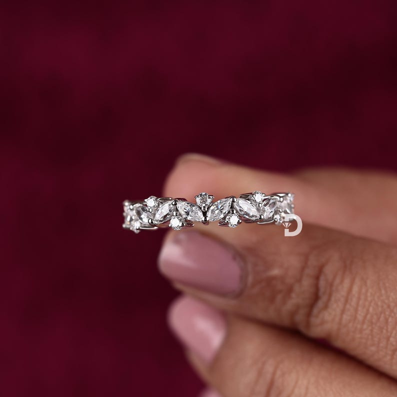 Designed for those who appreciate intricate details, this marquise diamond ring showcases a unique and artistic design. The marquise cut, known for its elongated shape and pointed edges, enhances the brilliance of the diamonds, making the ring appear larger and more luxurious. This distinct cut adds a regal and vintage touch, making it a standout piece.