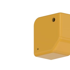 May include: A mustard-yellow, geometric-shaped object with rounded edges and two small holes. The object has a glossy finish and is set against a black background. The design is modern and minimalist.
