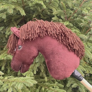 liver chestnut brown hobby horse with a stick steckenpferd