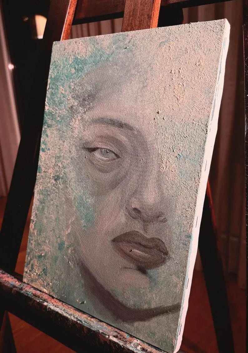 May include: A rectangular canvas painting featuring a close-up portrait of a face with dark lips and defined eyes. The artwork uses a textured application of paint in shades of teal, beige, and grey, creating a weathered, layered appearance.