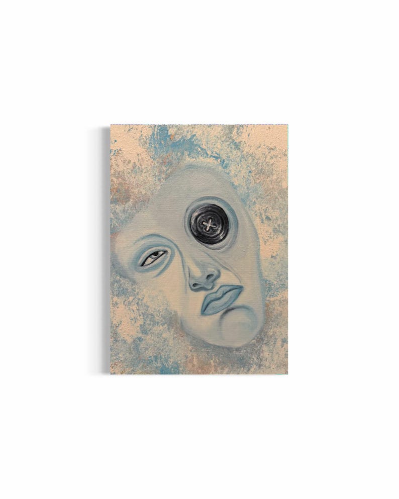 May include: A rectangular canvas painting featuring a pale blue face with one visible eye and a large black button covering the other eye socket. The background is a textured blend of light blue and beige tones, creating a weathered appearance.