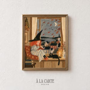 May include: A framed illustration of a person with red hair wearing a black pointed hat and striped clothing, reading a book by a window. A black cat sits nearby, and the scene shows a town at night with a crescent moon and falling autumn leaves.