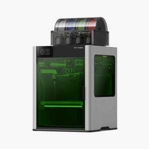 May include: A silver and black 3D printer with a clear top section holding multiple spools of filament in various colors. The printer has a green-tinted viewing window and the text "H2O" is visible on the front.