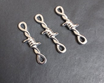 May include: Three silver-toned metal charms shaped like barbed wire. Each charm has a loop at the top for attaching to a bracelet or necklace.