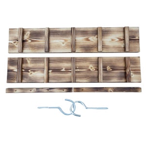 May include: A set of three wooden shelves with a rustic, burnt finish. The shelves are designed to be mounted on a wall and come with two metal hooks and screws for hanging items.