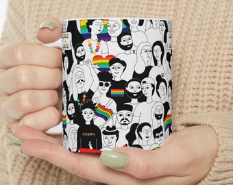 May include: White ceramic mug with a black and white illustration of a crowd of people with rainbow accents. The illustration includes a rainbow heart and the text "I Love You".