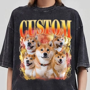 May include: Black t-shirt with a graphic of five Shiba Inu dogs in front of a yellow and orange flame design. The text "CUSTOM" is printed in yellow and orange letters above the dogs.