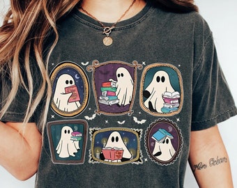 May include: A dark gray t-shirt with a graphic of ghosts reading books in frames. The text "More Books" is on the right sleeve of the shirt.
