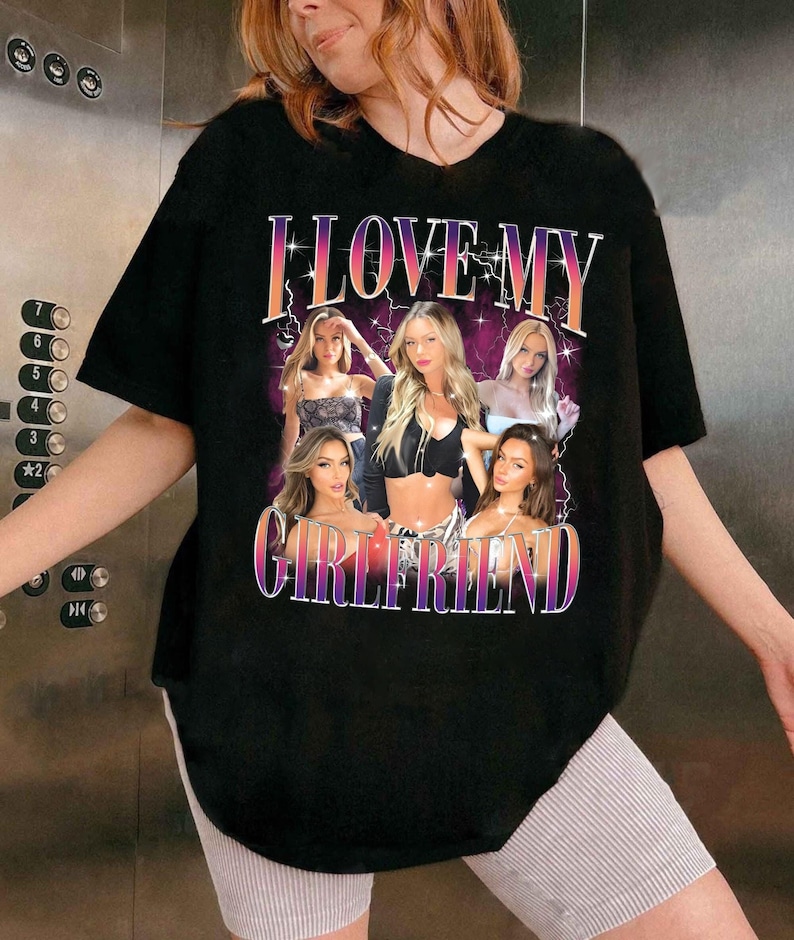 May include: Black oversized t-shirt with a graphic print of five women and the text "I LOVE MY GIRLFRIEND".