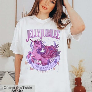 May include: White t-shirt with a purple and pink graphic of a winged unicorn with the text "Jelly Jubilee Official Fan Club".