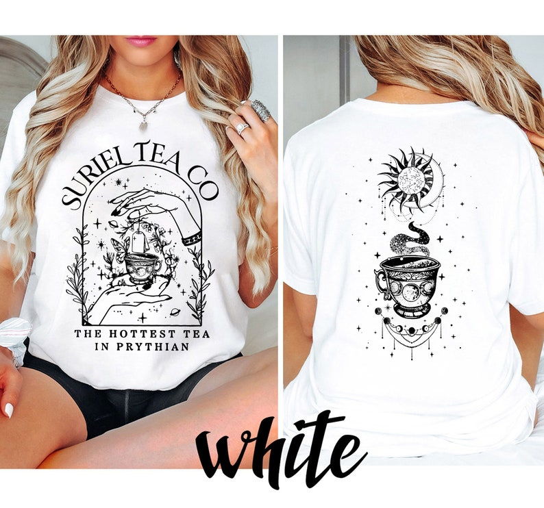 May include: White t-shirt with a black and white graphic design featuring a teacup, hands, and the text "Suriel Tea Co. The Hottest Tea in Prythian."