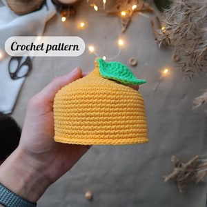 May include: Crochet pattern for a yellow crocheted lemon with a green leaf.