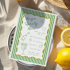 May include: A white printable recipe card with green and gold stripes. The card has a handwritten recipe for a Hugo Sprity Bar cocktail. The recipe includes ingredients like prosecco, soda water, mint leaves, and a slice of lime.