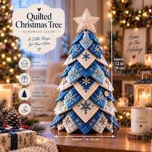 May include: A quilted Christmas tree decoration featuring layered fabric triangles in shades of blue and white with snowflake embroidery. The tree is topped with a fabric star and measures approximately 30 cm tall and 18 cm wide.