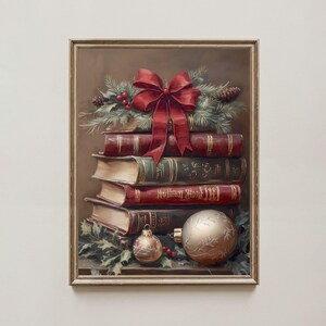 May include: A framed painting shows a stack of books decorated with a red bow, pine boughs, and baubles. The books are in shades of red, green, and brown. Two gold baubles and holly sprigs are at the base. The painting has a vintage, festive theme.
