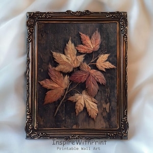 May include: A framed wall art piece depicting a branch of autumn leaves in shades of brown, orange, and red. The leaves are raised from the dark brown wooden background. The frame is ornate with a bronze finish. Text at the bottom reads "InspireWithPrint Printable Wall Art."