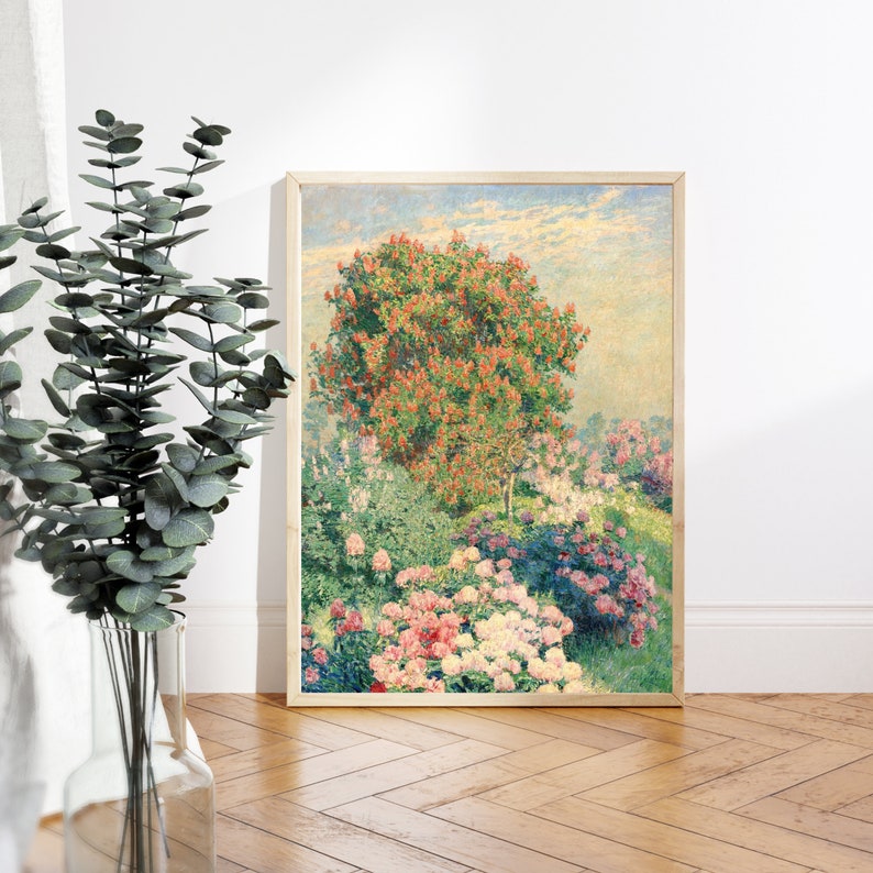 May include: A framed painting depicting a lush garden scene with a large red flowering tree in the center. The garden is filled with pink, white, and purple flowers. The sky is a soft blue with wispy clouds.