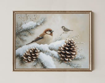 May include: Framed artwork featuring two birds perched on a snow-covered pine branch with pine cones. The birds have brown and gray feathers. The artwork is in a gold-colored frame.