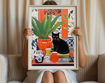 May include: A painting of a black cat sitting on a stack of books in front of a potted plant with green leaves. The plant is in a red pot and there are other colorful objects on the table, including a blue and white teacup, a yellow teacup, and a red pitcher.