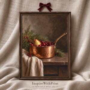 May include: A framed wall art print featuring a still life painting of a hammered copper saucepan filled with red cranberries and a single pear, accented by green pine sprigs on a wooden table with a draped cloth, topped with a velvet bow.