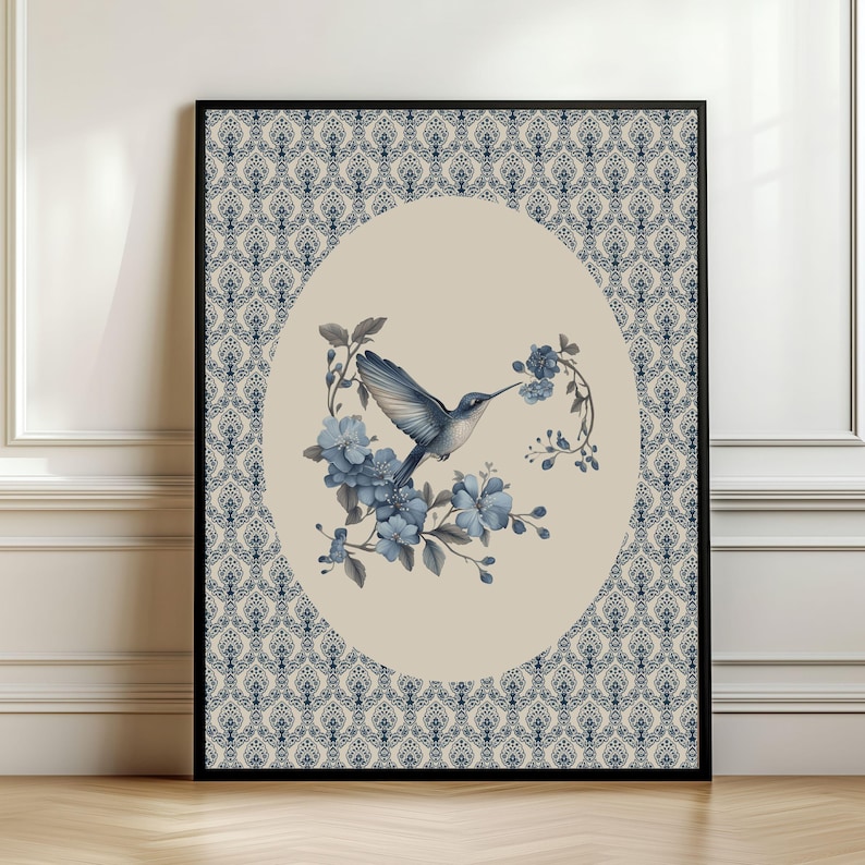 May include: A framed art print featuring a hummingbird and blue flowers within an oval frame. The hummingbird is depicted in flight, with its wings spread. The background has a damask pattern in navy blue and cream.