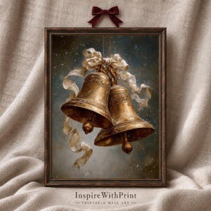 May include: A framed wall art print featuring two ornate gold bells tied together with a flowing cream-colored ribbon against a dark, snowy background. The frame is dark brown, and the text "Inspire With Print - PRINTABLE WALL ART" appears below.