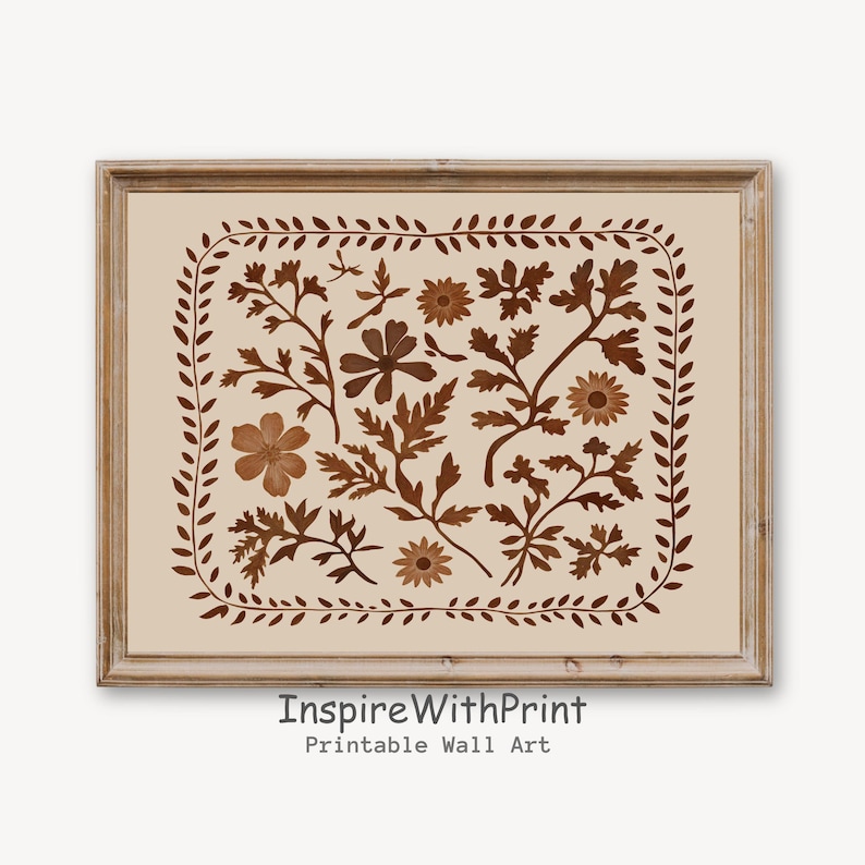 May include: A printable wall art print featuring a brown floral design with a cream background. The design is framed in a brown wood frame. The text "Inspire With Print" and "Printable Wall Art" is at the bottom of the print.