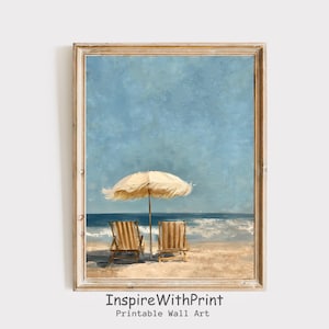 May include: A framed print of a beach scene with a light blue sky and ocean. A cream-colored beach umbrella and two wooden beach chairs are on the sand. The text "InspireWithPrint Printable Wall Art" is at the bottom.