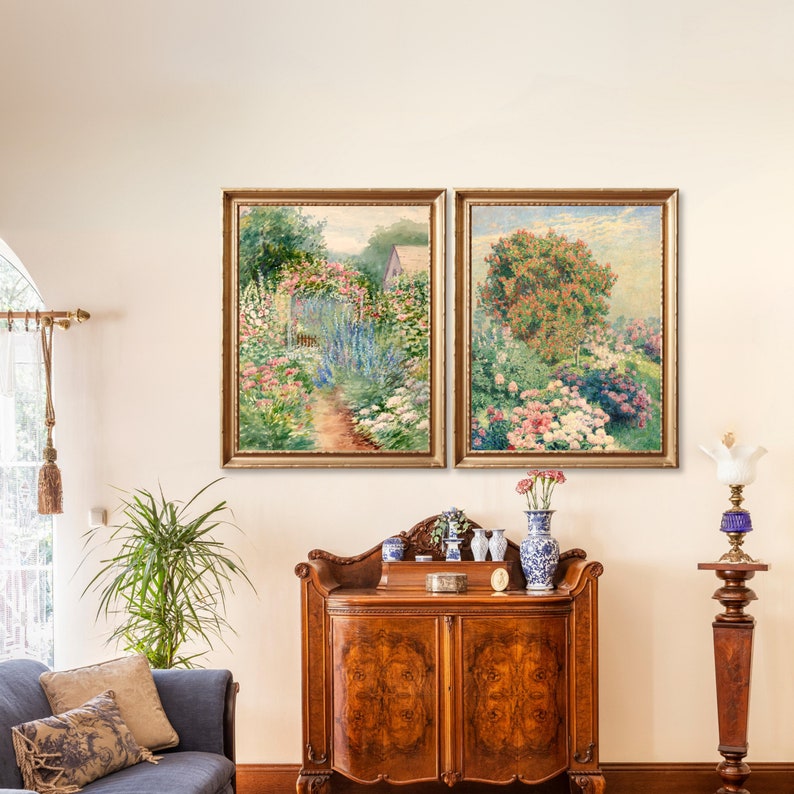 May include: Two framed paintings depicting lush gardens with vibrant flowers and greenery. The paintings are hung on a white wall above a wooden cabinet with decorative accents.