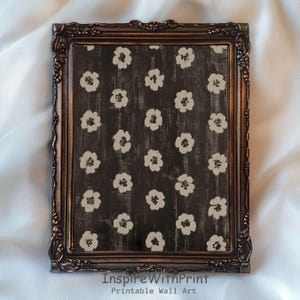 May include: A framed print featuring a dark background with a pattern of white floral designs. The frame is ornate with a bronze finish. The text "InspireWithPrint Printable Wall Art" is at the bottom.