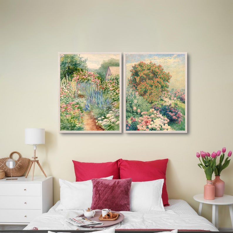May include: Two framed paintings of a garden with flowers in shades of pink, white, and blue. The paintings are hung on a wall above a bed with red and white bedding.
