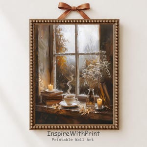May include: A framed wall art print featuring a rainy window scene with a stack of books, a steaming cup of coffee, a glass vase with white flowers, and two lit candles on a wooden sill. The frame is bronze with a beaded edge and a brown ribbon.