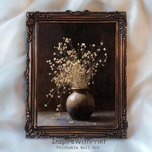 May include: A framed print featuring a still life of dried flowers in a brown vase. The vase is set against a dark background, and the frame has an ornate, bronze-colored design. The text "InspireWithPrint Printable Wall Art" is visible.