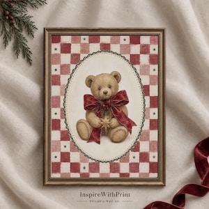 May include: A framed wall art print featuring a brown teddy bear wearing a large red bow and holding a gold star. The bear is centred within an oval frame against a background of red and white checkered squares with small dark stars.