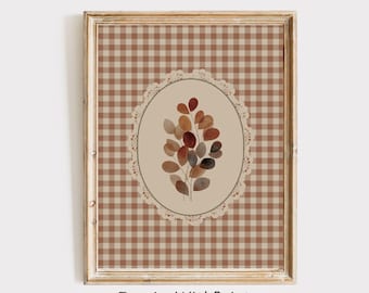 May include: Framed wall art featuring a watercolor illustration of a botanical arrangement. The artwork is set against a brown and tan gingham pattern, with a central oval design. The text "InspireWithPrint Printable Wall Art" is at the bottom.