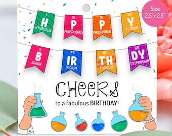 May include: A birthday card with a science theme. The card features a string of colorful pennants with the chemical symbols and names for hydrogen, phosphorus, yttrium, boron, iridium, thorium, and dysprosium. The card also features a cartoon hand holding a beaker and the text "CHEERS to a fabulous BIRTHDAY!" and "It's Card Station".