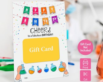 May include: A printable gift card holder with a yellow gift card space and the text "CHEERS to a fabulous BIRTHDAY!". The design includes colorful banners with periodic table elements and laboratory flasks. The text "Gift Card Not Included" is also present.