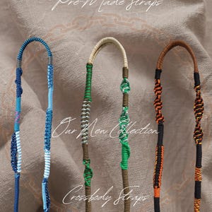 May include: Four pre-made crossbody straps in different colors and patterns. The straps are made of braided cord and have a black metal clasp at each end. The text "Our New Collection" and "Crossbody Straps" is visible in the image.